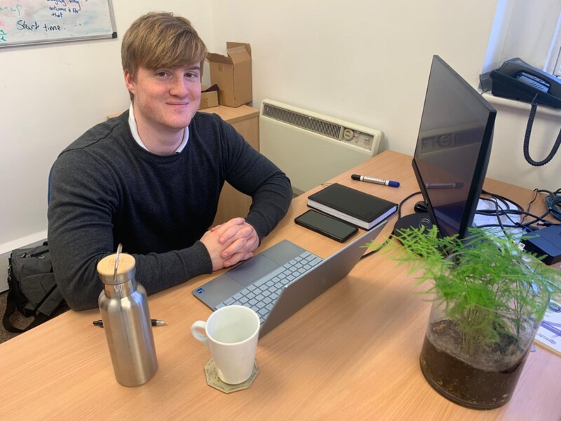 Oliver sat at his desk in the office