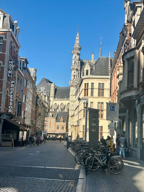 Leuven street scene Lots of bikes and a spire in Leuven