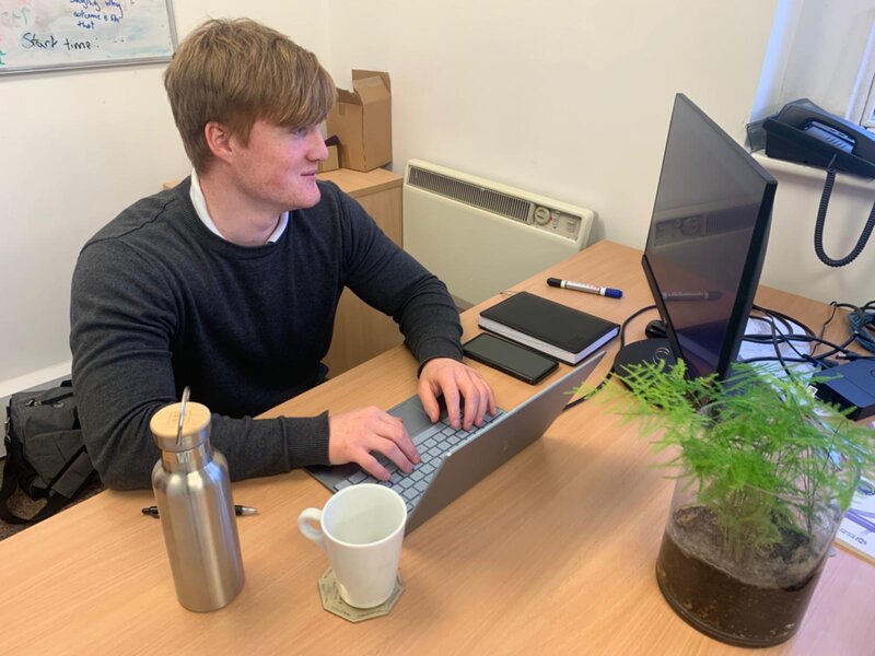 Oliver looking at his computer